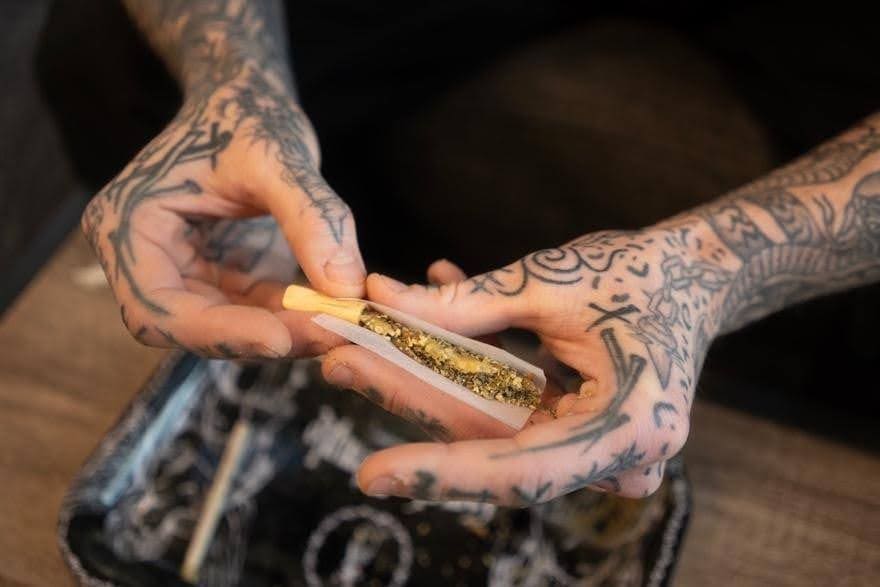 Vape pen with cannabis concentrate, close-up of hands with tattoos preparing to use a vaporizer, cannabis extracts, cannabis culture, cannabis accessories, hobby, recreational marijuana use.