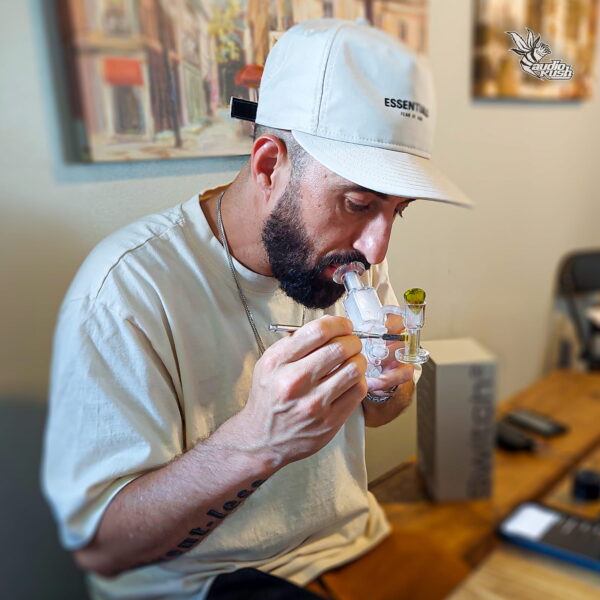 Man using a dab rig indoors.
