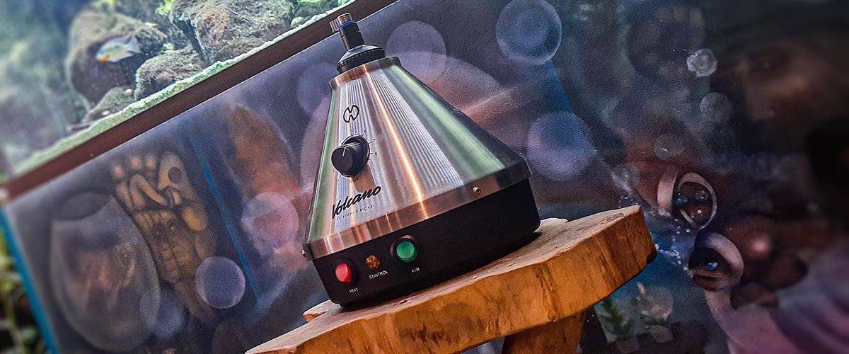 High-quality vaporizer device on wooden stand, modern dab pen for concentrates, portable vaporizer for concentrates and dry herbs, sleek design, essential for cannabis enthusiasts.