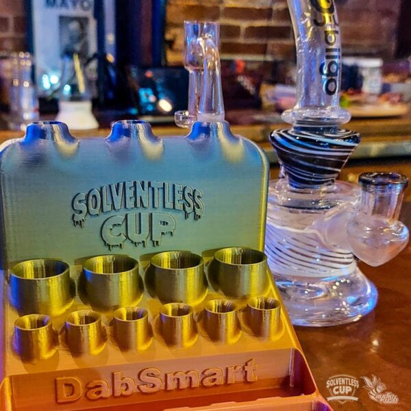 Solventless Cup technicolor display by DabSmart next to glass dab rig at Roaring 420s Lounge in Buffalo, NY