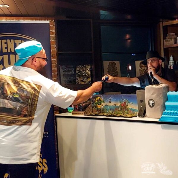 Man in blue hat receiving medal at Solventless Cup awards ceremony
